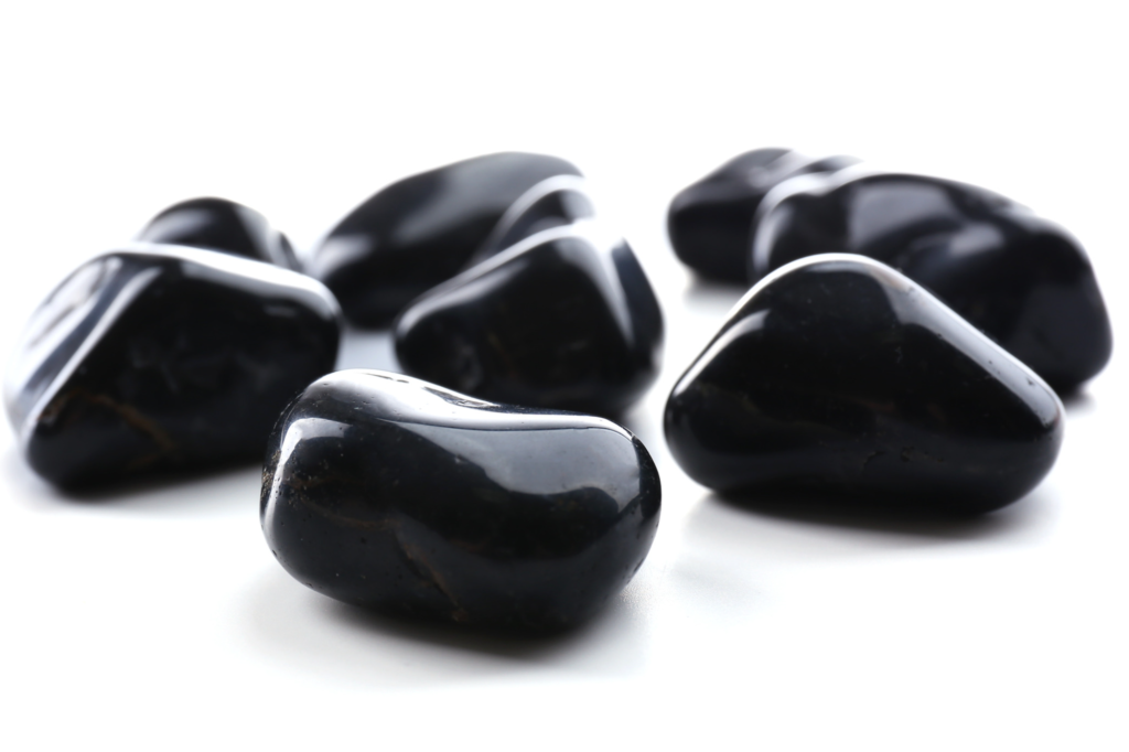 A close-up picture of shiny polished black onyx stones
